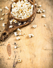 Popcorn in a wooden bowl on the Board.