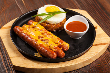 sausages in a pan with cheese