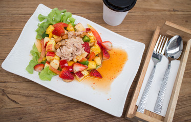 Thai style spicy salad on wood table.