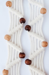 Macrame with wooden beads on a white background