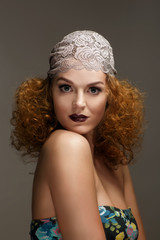 Old-fashioned red-haired woman with professional make up and hairstyle