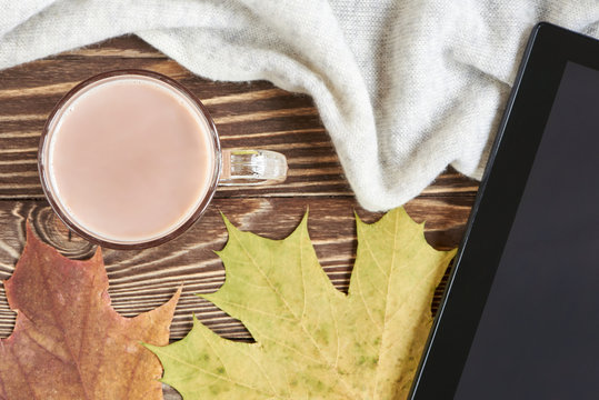 Cocoa cup, autumn leaves, and tablet pc