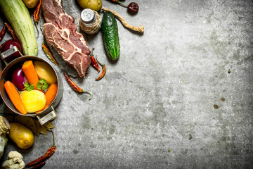 Ingredients for soup with vegetables, spices and meat.