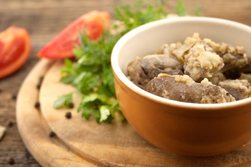 Roasted chicken liver with onion on wooden cutting board. Select