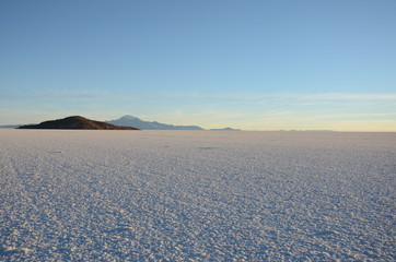 Dark mountain Salar de Uyuni,  the largest salt flat in the world