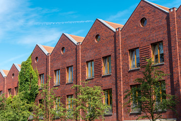 Fototapeta na wymiar Serial houses made from red bricks seen in Berlin, Germany