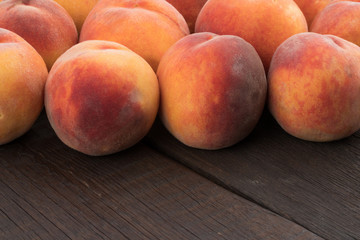 Ripe peaches on old rustic table.