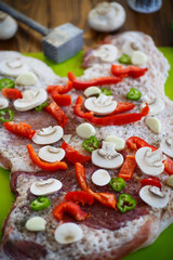 raw meat with spices, vegetables and mushrooms