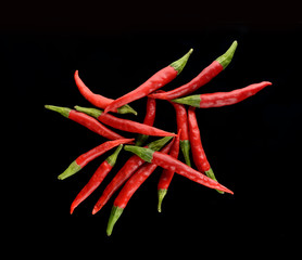 Mini hot red peppers on black background