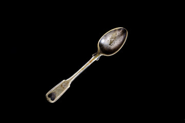 old vintage spoon on a black background