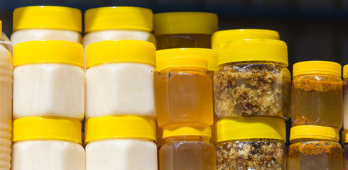 Honey in bottles as background