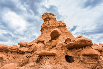 Fototapeta na wymiar Goblin canyon hoodoos in valley state park with dark stormy clouds and hole