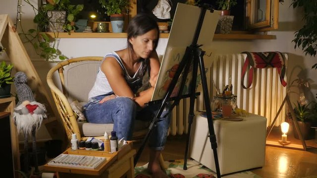 Young woman drawing something ih ner studio.

