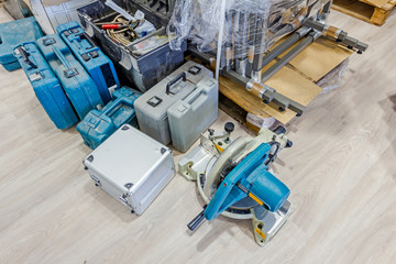 Variety of carpentry tools in tool box on wooden floor