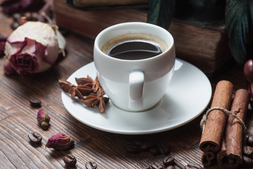 Cup of coffee, dry rose and old telephone