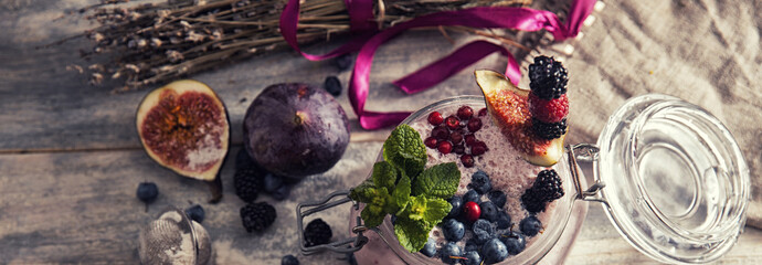 bright detox smoothie with berries on wooden background bowl
