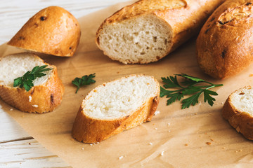 Sliced French Baguette on white rustic table