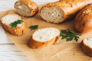 Sliced French Baguette on white rustic table