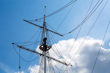 Ship's mast sailboat, romance of travel and far wandering. Background marine themes. Ocean transport ship under sail.