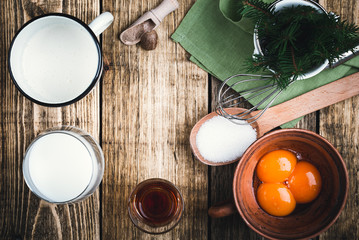Fototapeta na wymiar Eggnog ingredients on rustic wooden table, top view