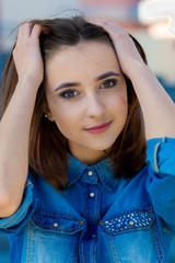 Portrait of a beautiful girl in blue on stairs