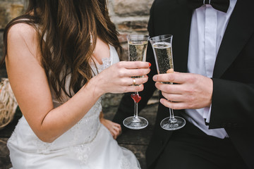 Beautiful wedding couple drinking champagne