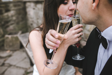 Beautiful wedding couple drinking champagne