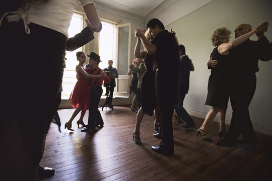 Couples dancing on wooden floor
