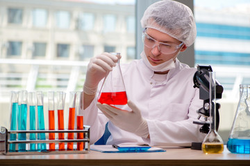 Man working in the chemical lab on science project