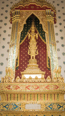 Golden angel statue and  Thai art architecture detail main ordination hall in Wat Arun buddhist temple in Bangkok, Thailand
