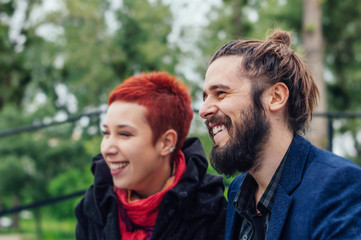 Fototapeta premium Happy couple thinking and looking sideways sitting outside