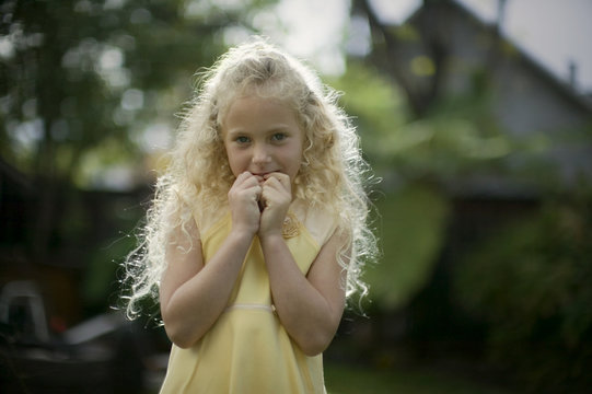 girl with her hands in mouth