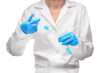 Doctor pouring blue liquid from syringe into test tube