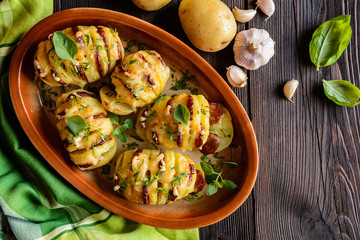 Baked potatoes stuffed with smoked sausage slices, cheese, garlic and herbs