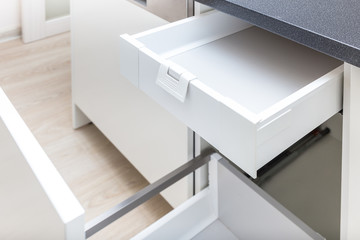 Opened kitchen drawer with high front for garbage bin and inner drawer inside for sundries and other small objects 