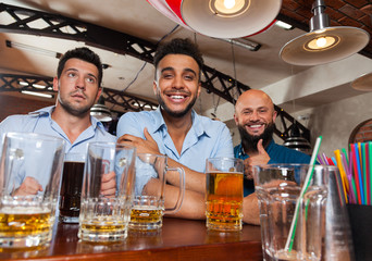 Man Group In Bar Hold Glasses Happy Smiling, Drinking Beer, Mix Race Cheerful Friends Meeting