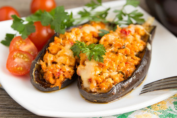 Baked stuffed eggplant with meat, vegetables and cheese.