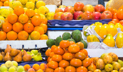 Colorful selection of different fresh delicious fruits and vegetables spread out, blurry effect