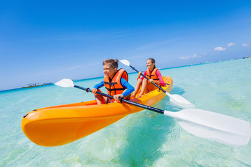 Kids paddling in kayak