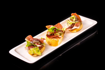 Bruschetta tomato, olive oil, arugula and cream cheese on a bagu