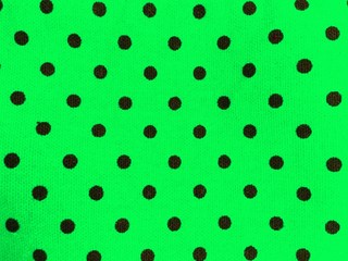 Green and black polka dot abstract background