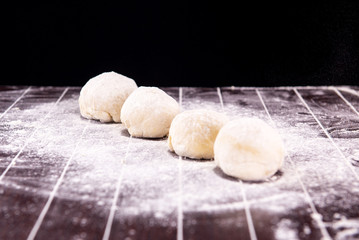 Cook preparing dough for baking in the kitchen