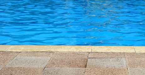 Edge of outdoor swimming pool for background with copy space