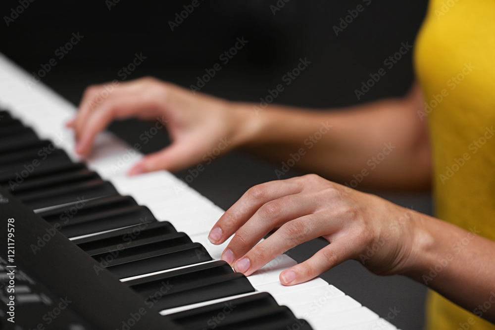 Wall mural female hands playing on synthesizer