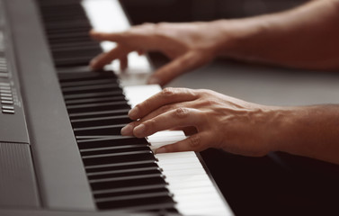 Fototapeta na wymiar Male hands playing on synthesizer