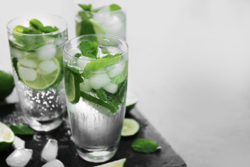 Cold fresh cocktails with lime on slate plate