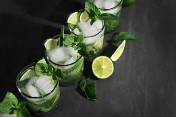Cold fresh cocktails with lime on grey background