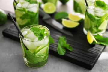 Cold fresh cocktail with lime on table