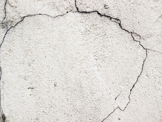 white and gray textured wall with cracks