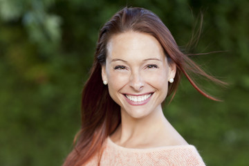 Naklejka premium Smiling Woman Outside Looking At The Camera